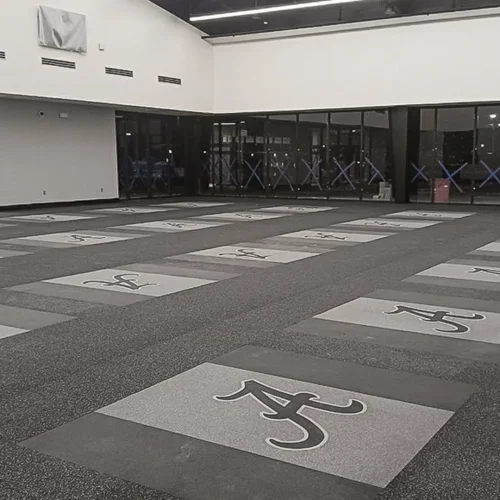 Weightroom at Anna High School with inlaid rubber platforms and installed engineered graphics logos by our team.