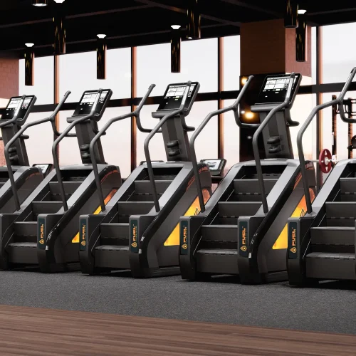 A row of branded stair climber machines in a modern wellness center setting.